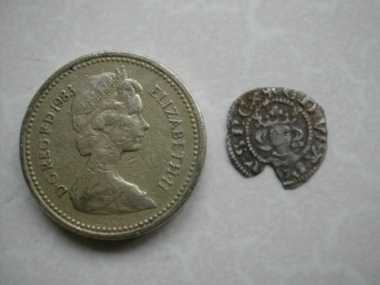 Small Hammered next to pound coin